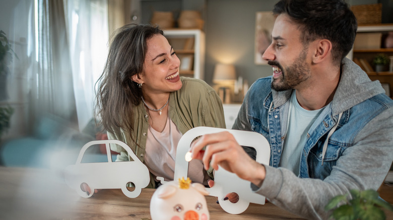 An ecstatically happy couple saving for a new car.