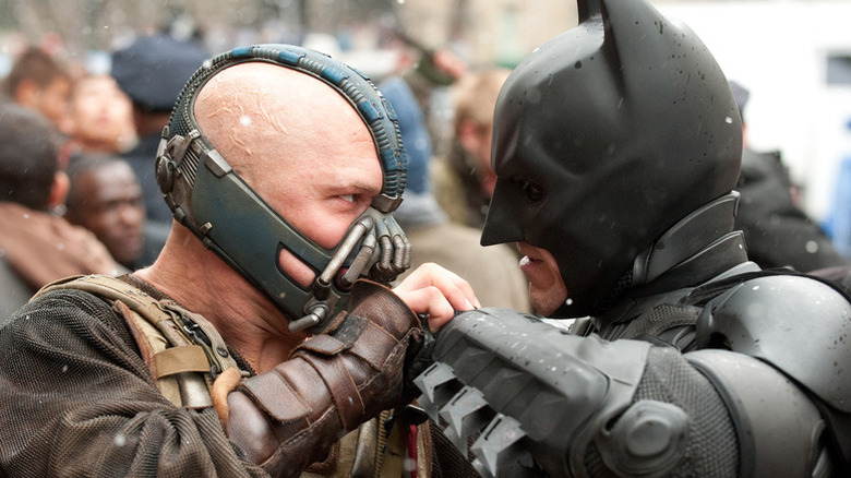 Bane and Batman holding hands in a loving embrace as they puch each other real hard in The Dark Knight Rises