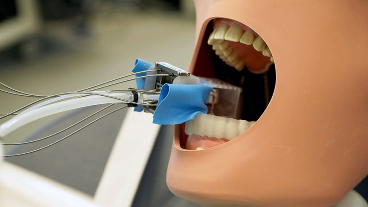 A dental robot is attached to a dental dummy.