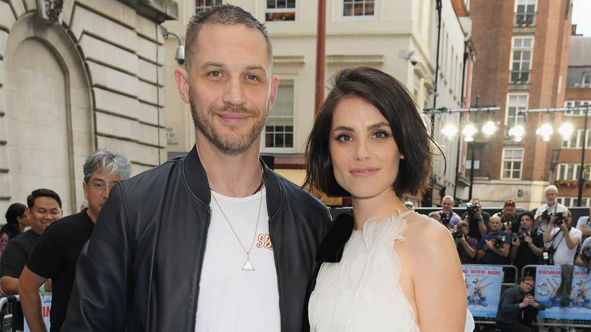 Tom Hardy and Charlotte Riley standing together at a UK film premiere in London.