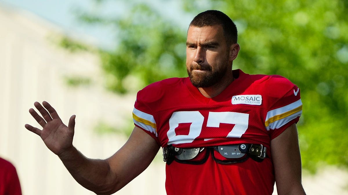 Travis Kelce greets fans as he arrives at training camp.
