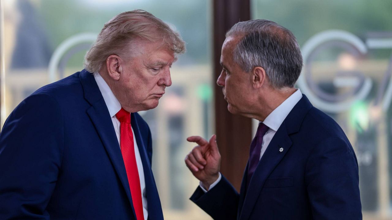 President Donald Trump speaks with Canadian Prime Minister Mark Carney, right, at a working lunch with leaders of G7 and the Middle East in Evian-les-Bains, France, Tuesday, June 16, 2026. (Evelyn Hockstein/Pool Photo via AP, File)