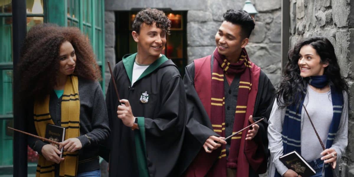Harry Potter fans in robes with wands in Universal's Diagon Alley