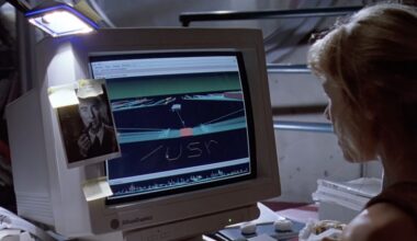 A still from Jurassic Park, showing a young woman sitting at an SGI workstation