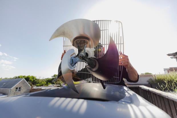 Moshe Pomerantz works on an air-conditioning unit in Chicago, June 30, 2026. With Chicago and much of the country in the grips of a heat wave, air-conditioning technicians are enduring sweltering temperatures to keep systems working. (Jim Vondruska/The New York Times)