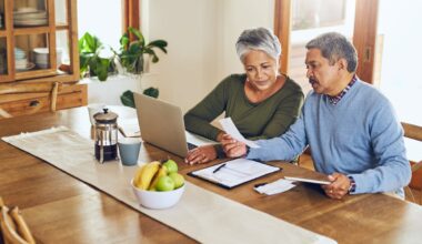 Two people sitting at table and working.