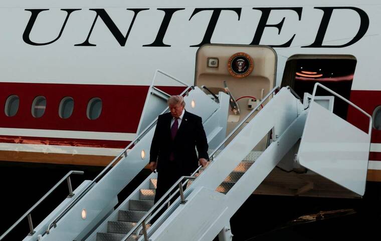 REUTERS/KYLIE COOPER
President Donald Trump deboards the new Air Force One, a plane gifted by Qatar, upon arrival at Ellsworth Air Force Base in Belle Fourche-Cheyenne Valleys, South Dakota, on July 3. Trumps Justice Department will withdraw subpoenas issued to New York Times journalists who reported on security concerns about the president flying on a Qatari-donated Air Force One, a prosecutor said at a court hearing today.