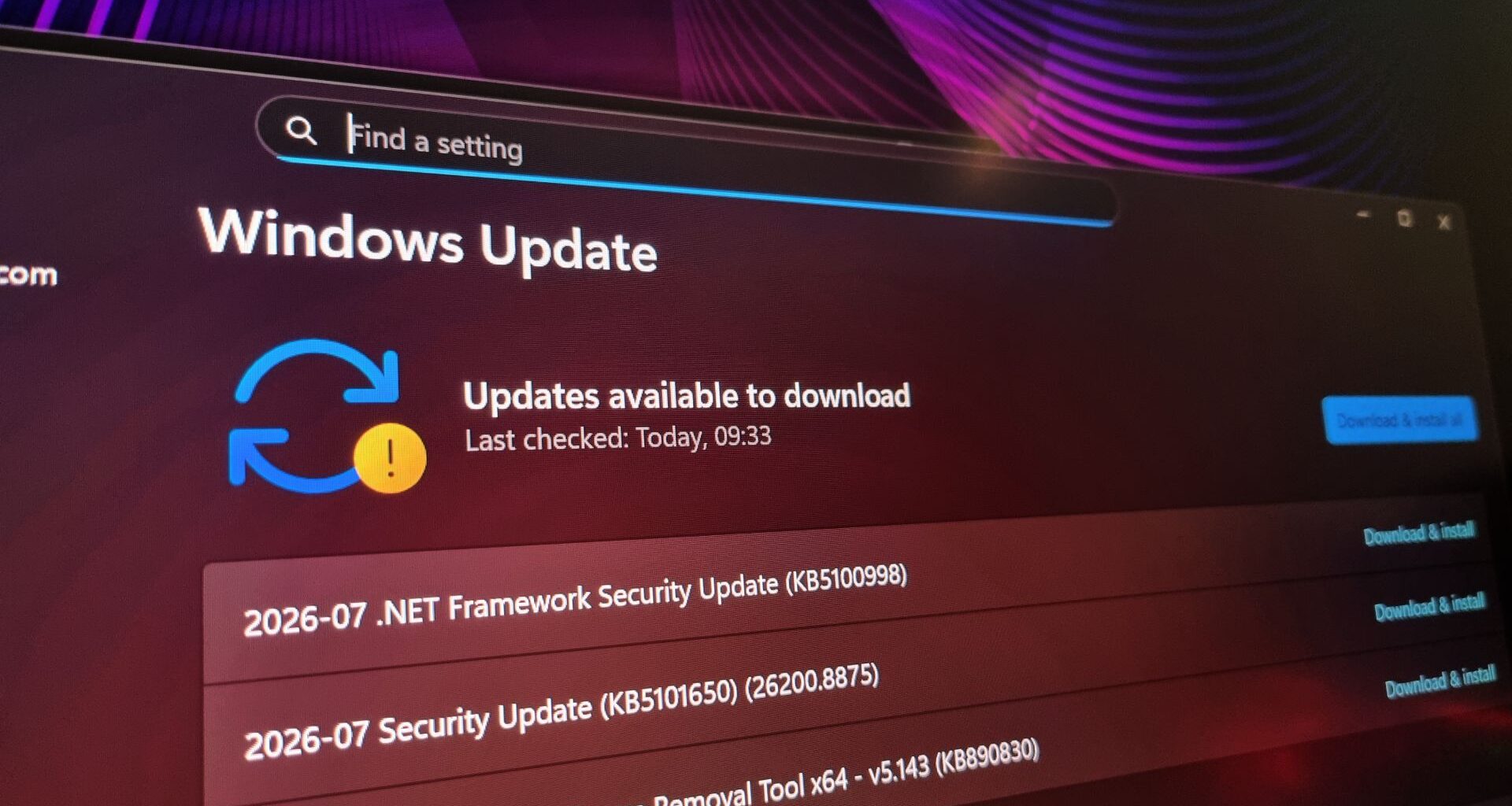 A photo of a gaming monitor displaying queued Windows updates