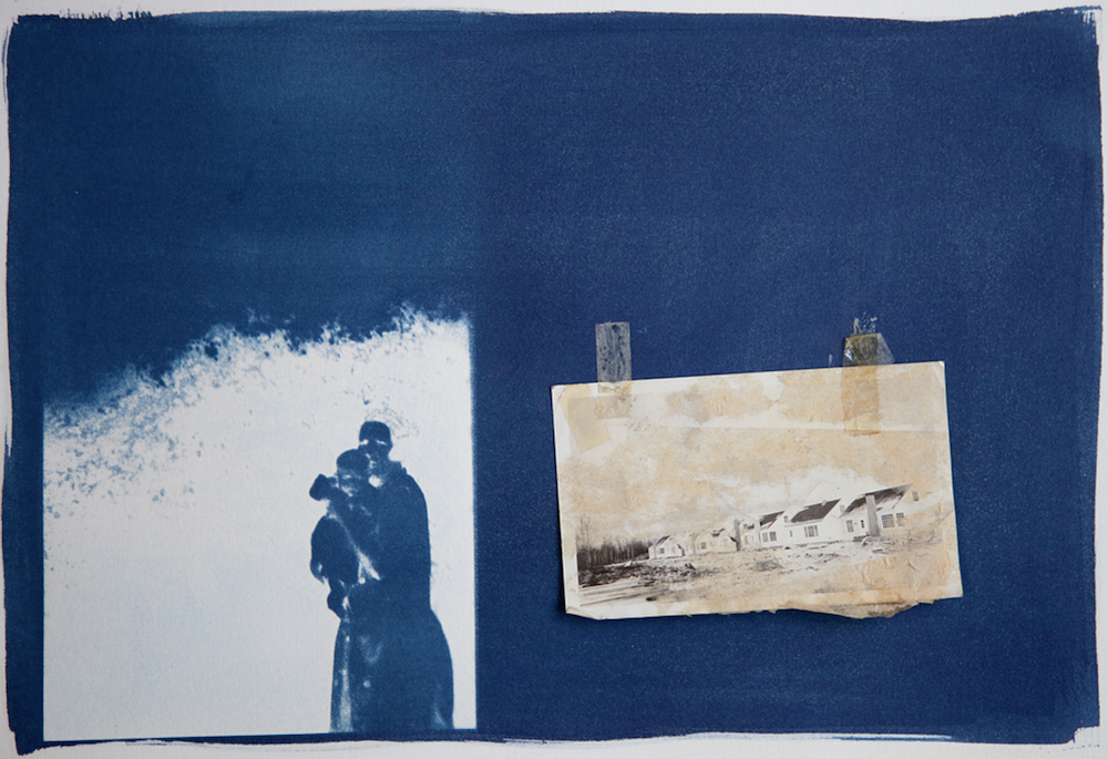 A deep blue cyanotype book spread with a silhouetted figure and a pinned landscape photograph, © Ann Mitchell.