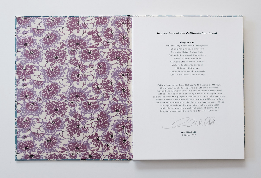 An open artist book with a patterned pink page and a typed letter or statement page, © Ann Mitchell.