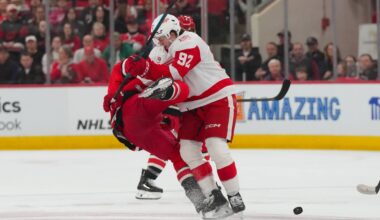 Feb 28, 2026; Raleigh, North Carolina, USA;  Detroit Red Wings center Marco Kasper (92) checks Carolina Hurricanes left wing Taylor Hall (71) during the first period at Lenovo Center. Mandatory Credit: James Guillory-Imagn Images