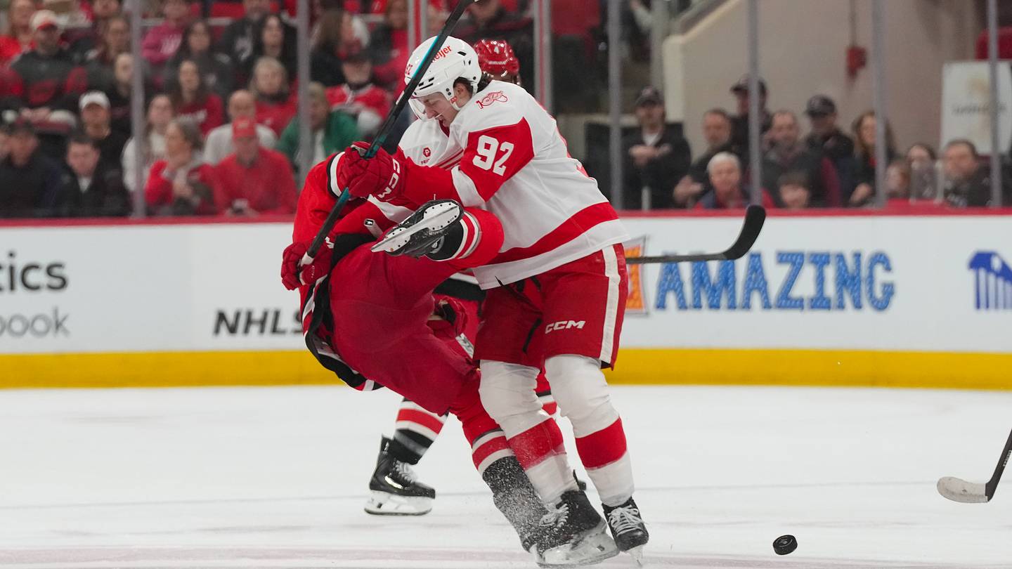 Feb 28, 2026; Raleigh, North Carolina, USA;  Detroit Red Wings center Marco Kasper (92) checks Carolina Hurricanes left wing Taylor Hall (71) during the first period at Lenovo Center. Mandatory Credit: James Guillory-Imagn Images