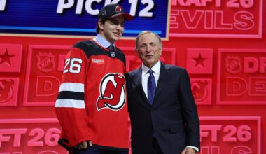 Alexander Command reacts beside NHL Commissioner Gary Bettman after being selected with the twelfth pick in the first round of the 2026 NHL Draft by the New Jersey Devils at KeyBank Center. Mandatory Credit: Timothy T. Ludwig-Imagn Images