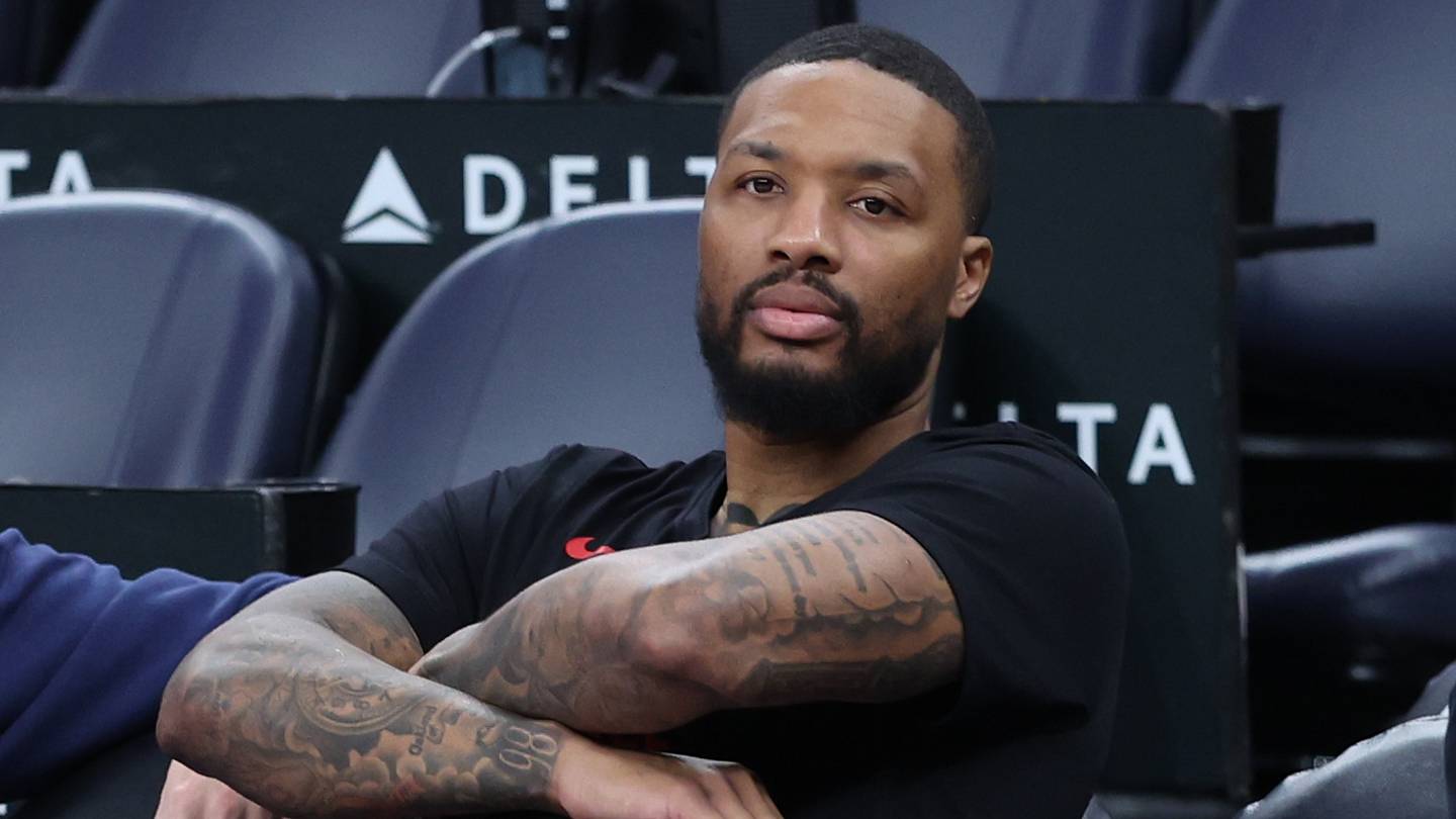 Oct 29, 2025; Salt Lake City, Utah, USA; Portland Trail Blazers guard Damian Lillard (0) watches the team warm up before the game against the Utah Jazz at Delta Center. Mandatory Credit: Rob Gray-Imagn Images