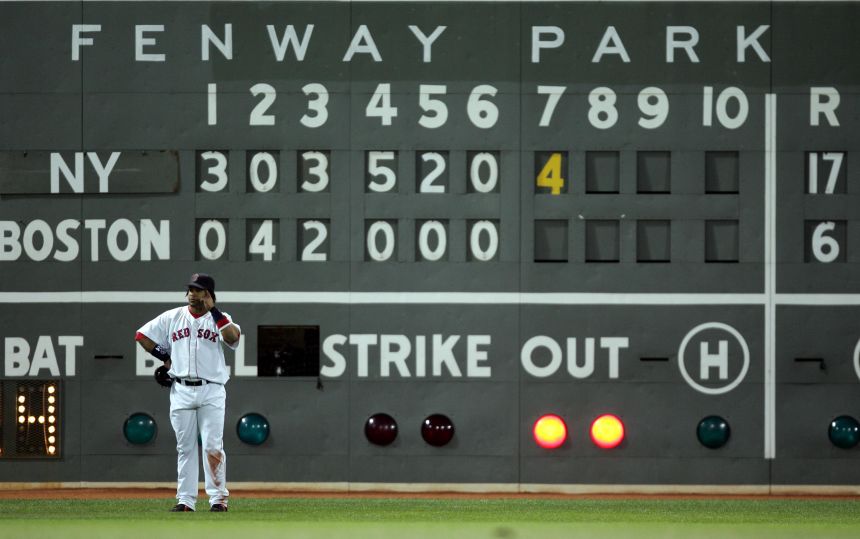 Ramirez stands near the Fenway Park scoreboard showing the New York Yankees winning 17-6 in the seventh inning of Game 3 of the American League Championship Series in Boston in 2004.