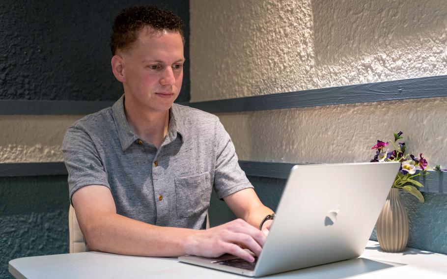 A man typing on a laptop.