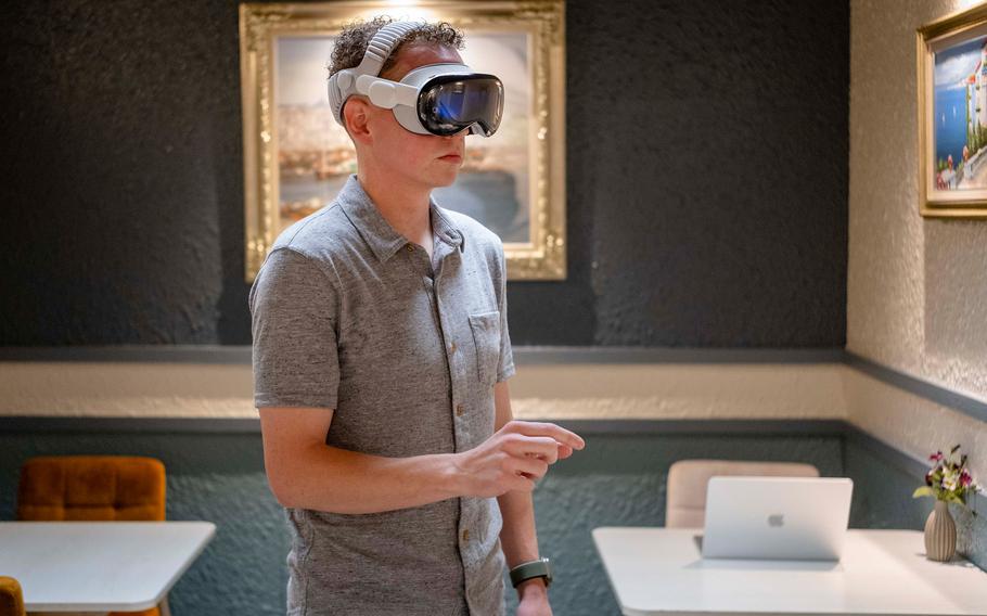 A man standing while using a virtual reality headset.