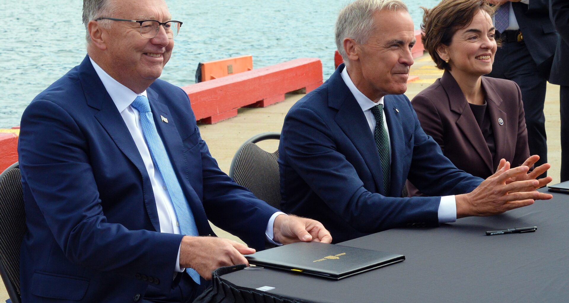 Newfoundland and Labrador Premier Tony Wakeham, Prime Minister Mark Carney and Quebec Premier Christine Fréchette take part in a signing ceremony