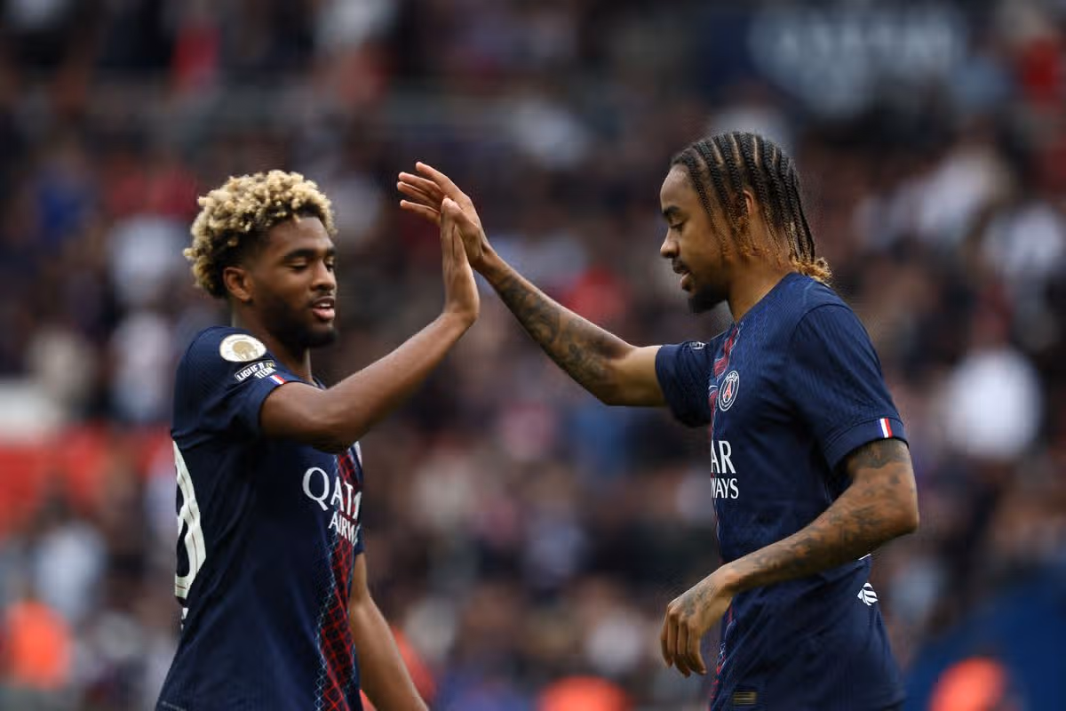 Paris Saint-Germain's French forward #29 Bradley Barcola (R) celebrates with Paris Saint-Germain's French forward #49 Ibrahim Mbaye after scoring his team's second goal during the French L1 football match between Paris Saint-Germain (PSG) and RC Lens at the Parc des Princes stadium in Paris, on September 14, 2025. (Photo by FRANCK FIFE/AFP via Getty Images)