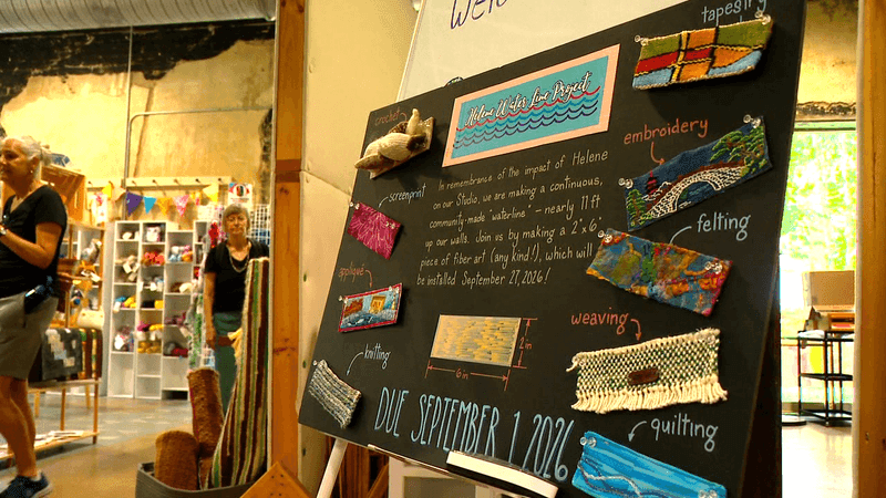 AUG. 8, 2026 - The community is helping a local art studio, Local Cloth, with an art project marking the height reached by floodwater during Helene. The studio hosted a drop-in event where people could stop by and make fiber art strips for the project. (Photo credit: WLOS Staff)