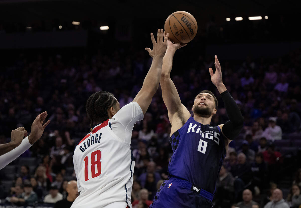 Sacramento Kings guard Zach LaVine (8) puts up a shot over Washington Wizards forward Kyshawn George (18) in the first half on Friday, Jan. 16, 2026, at Golden 1 Center.