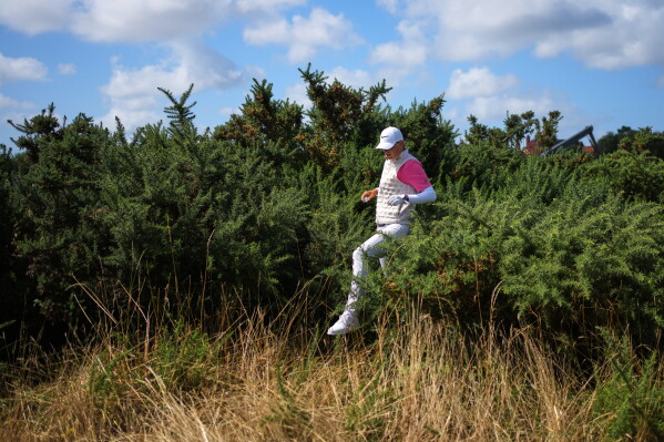 Helen Briem, of Germany, gestures after playing into the thick rough on the 18th hole during the second round of the Women's British Open golf championship in Lytham St Annes, England, Friday, July 31, 2026. (AP Photo/Jon Super)