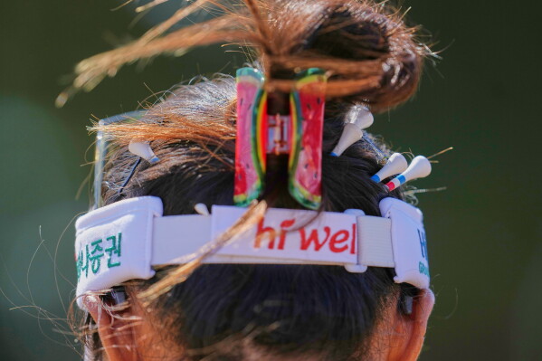 Tees are pinned in the hair of Lydia Ko, of New Zealand, on the 3rd hole during the second round of the Women's British Open golf championship in Lytham St Annes, England, Friday, July 31, 2026. (AP Photo/Jon Super)