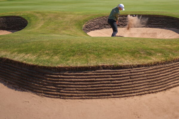 Charley Hull, of England, plays a shot out of a bunker on the 17th hole during the second round of the Women's British Open golf championship in Lytham St Annes, England, Friday, July 31, 2026. (AP Photo/Jon Super)