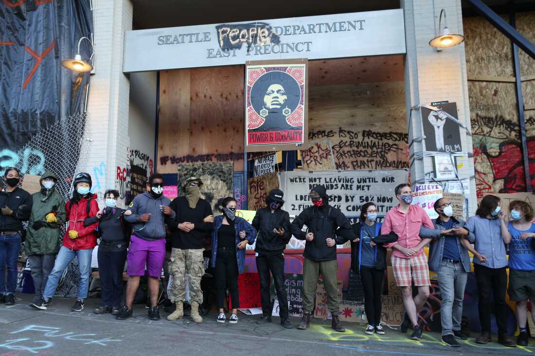 CHOP demonstrators fearing the police returning to take back the E. Precinct of the Seattle Police Department, stage a drill outside the building, on June 22, 2020.