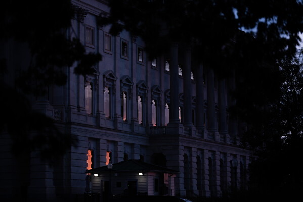 The sun sets behind the U.S. Capitol, Tuesday, July 28, 2026, in Washington. (AP Photo/Allison Robbert)
