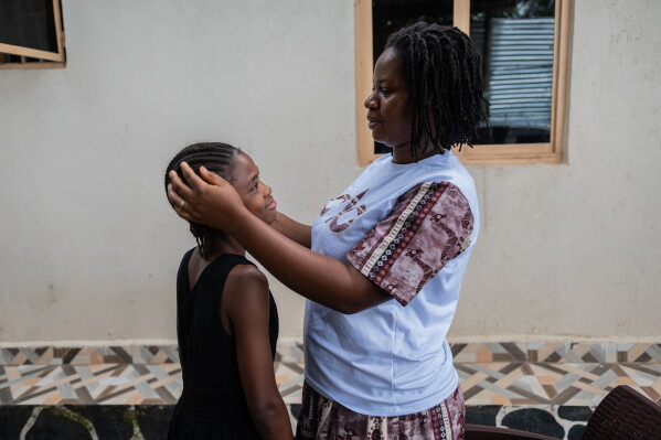 Esther Lutula, a 26 year-old woman who is four months pregnant and a mother of four, who stopped going for prenatal checkups shortly after the current Ebola outbreak, caresses her child outside her house in Bunia, northeastern, Congo, Tuesday, June 16, 2026. (AP Photo/Moses Sawasawa)
