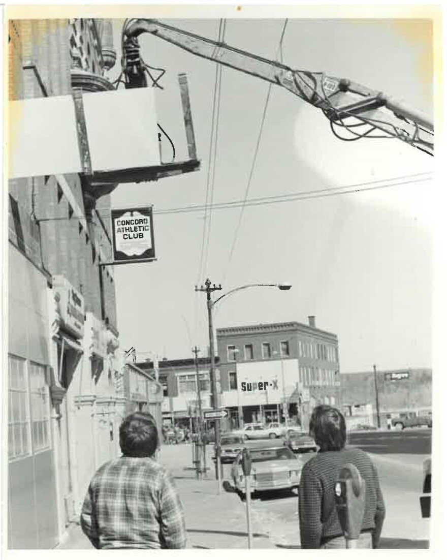 A crane lifts equipment in through a window at the Fowler Building on Pleasant St, where WEVO launched in 1981.
