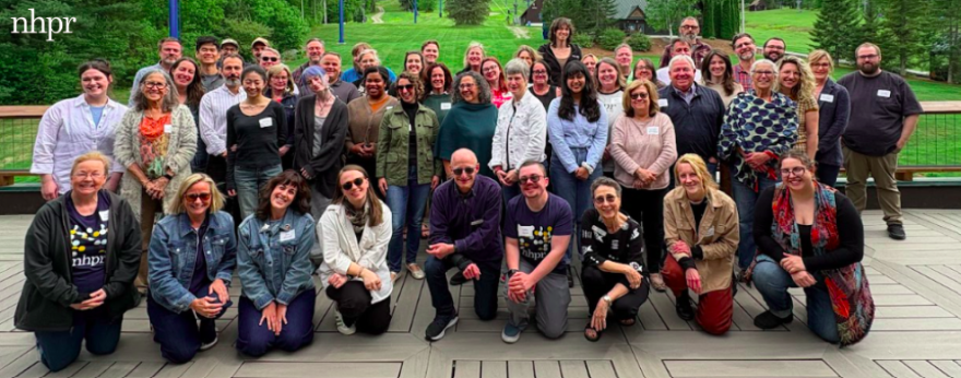 A group of NHPR staffers smile for a team photo at the organization's 2026 spring retreat.