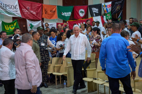 Cuba's President Miguel Díaz-Canel, center, arrives for the opening of the Continental Assembly, attended by ALBA delegates supporting Cuba and marking the centenary of the birth of Fidel Castro, in Havana, Thursday, Aug. 6, 2026. (AP Photo/Ramon Espinosa)