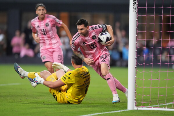 Inter Miami forward Lionel Messi (10) picks up the ball and runs after scoring his side's first goal past Atletico de San Luis goalkeeper Andres Sanchez (1) during the first half of a Leagues Cup soccer match, Wednesday, Aug. 5, 2026, in Miami. (AP Photo/Rebecca Blackwell)