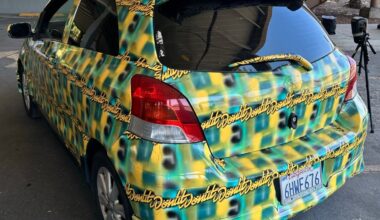 a photo of the toyota yaris covered in a pattern made by Bill Swearingen, as part of a test to see if it can defeat surveillance camera detection.