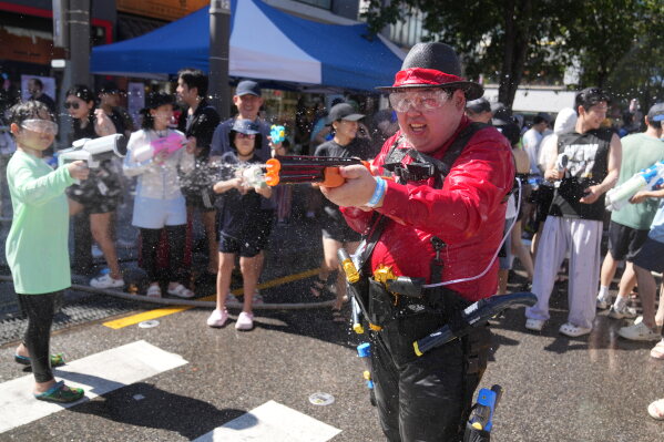Participants spray water from their water guns during a water gun festival in Seoul, South Korea, Saturday, Aug. 8, 2026. (AP Photo/Lee Jin-man)