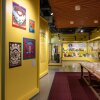 This exhibition space with yellow walls displays Grateful Dead memorabilia such as posters, paper documents and a yellow teddy bear.