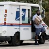 U.S. Postal Service mail carrier Marc Jacques makes a delivery in Miami in March.