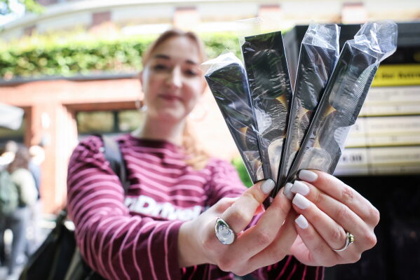 Jana Timm is holds four pairs of special solar viewing glasses that she bought at the Hamburg Planetarium to safely observe the partial solar eclipse on Wednesday, Aug. 12, 2026 in Hamburg, Germany. (Christian Charisius/dpa via AP)