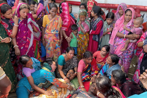 Relatives mourn over the bodies of victims of a suspected gas leak at a shipbreaking yard during the dismantling of a decommissioned ship in Sitakunda area of Chattogram, Bangladesh, Friday, Aug. 14, 2026. (AP Photo)
