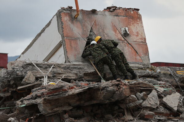 Rescuers assess earthquake damage in Cali, Colombia, Sunday, Aug. 16, 2026. (AP Photo/Santiago Saldarriaga)
