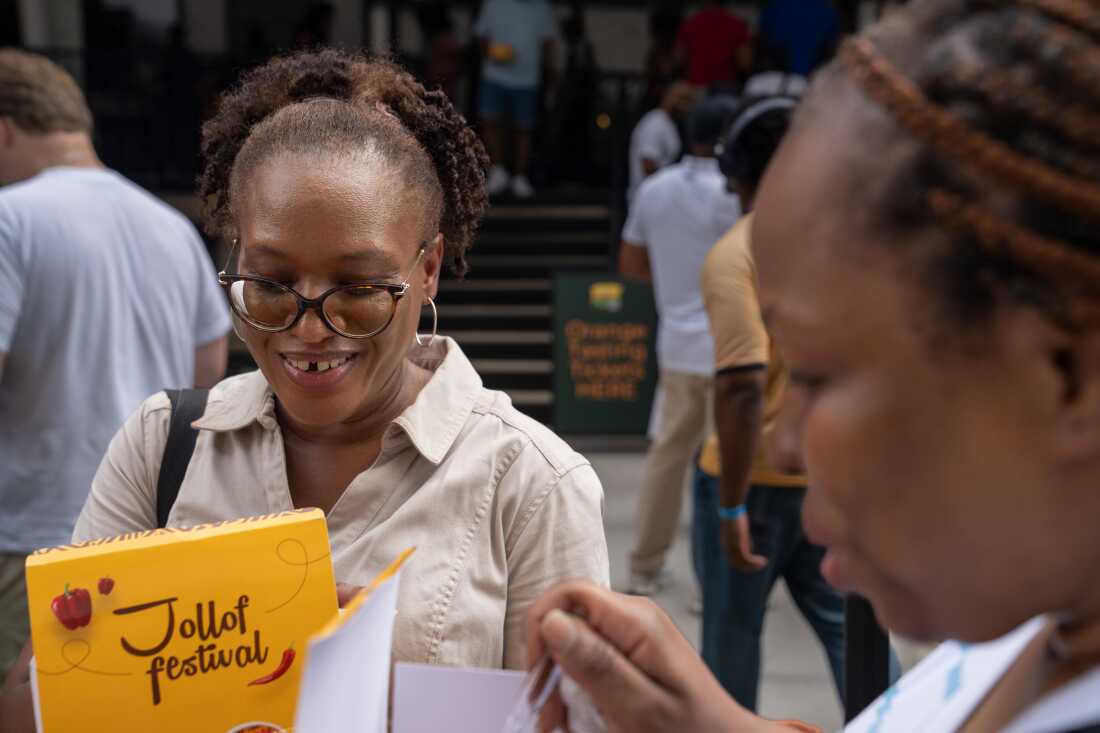 Shakesha Coleman, left, and Julie Agbasi, try some of the samples of Jollof at the festival.