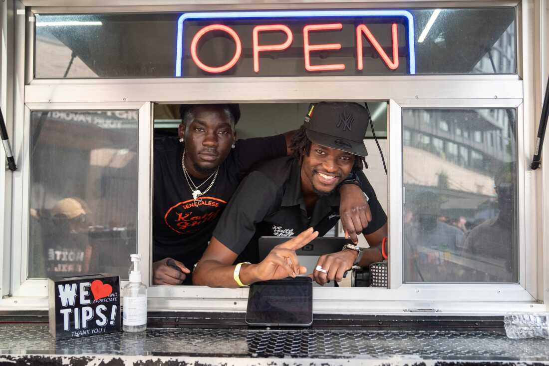 Mamadou Koité, right, and Bai Saine at the window of the Koité Grill food trailer at Union Market, which serves Senegalese and West African food.