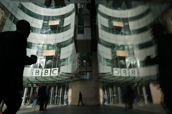 Pedestrians walk outside the BBC Headquarters in London, Wednesday, Nov. 12, 2025. (AP Photo/Kin Cheung, file)