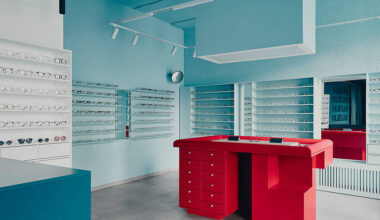 hubarch pairs pale blue interiors with red counter at optics boutique