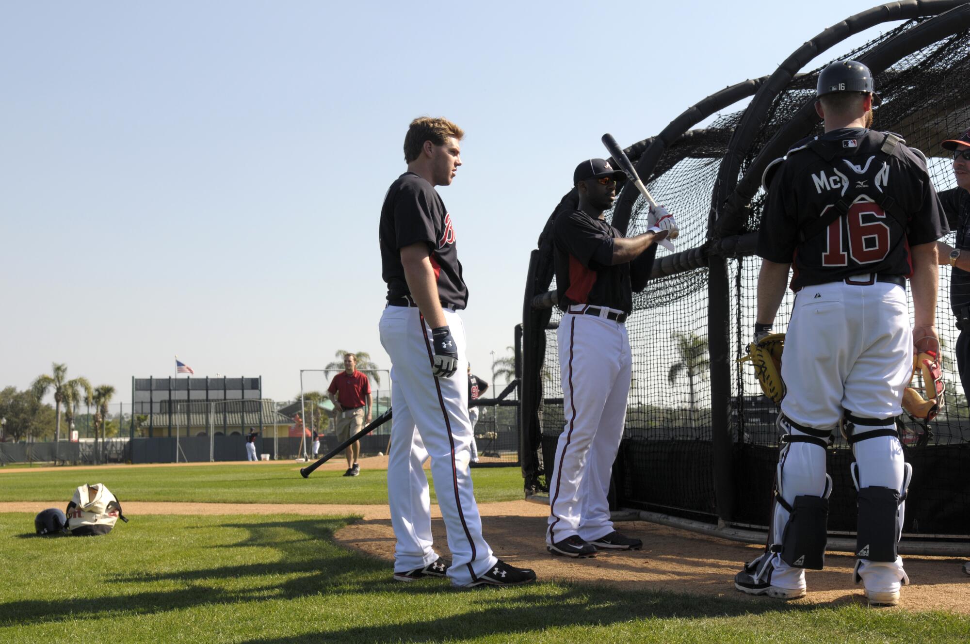 The Braves' Freddie Freeman, left, Jason Heyward, center, and Brian McCann chat during a workout at spring training in 2011.