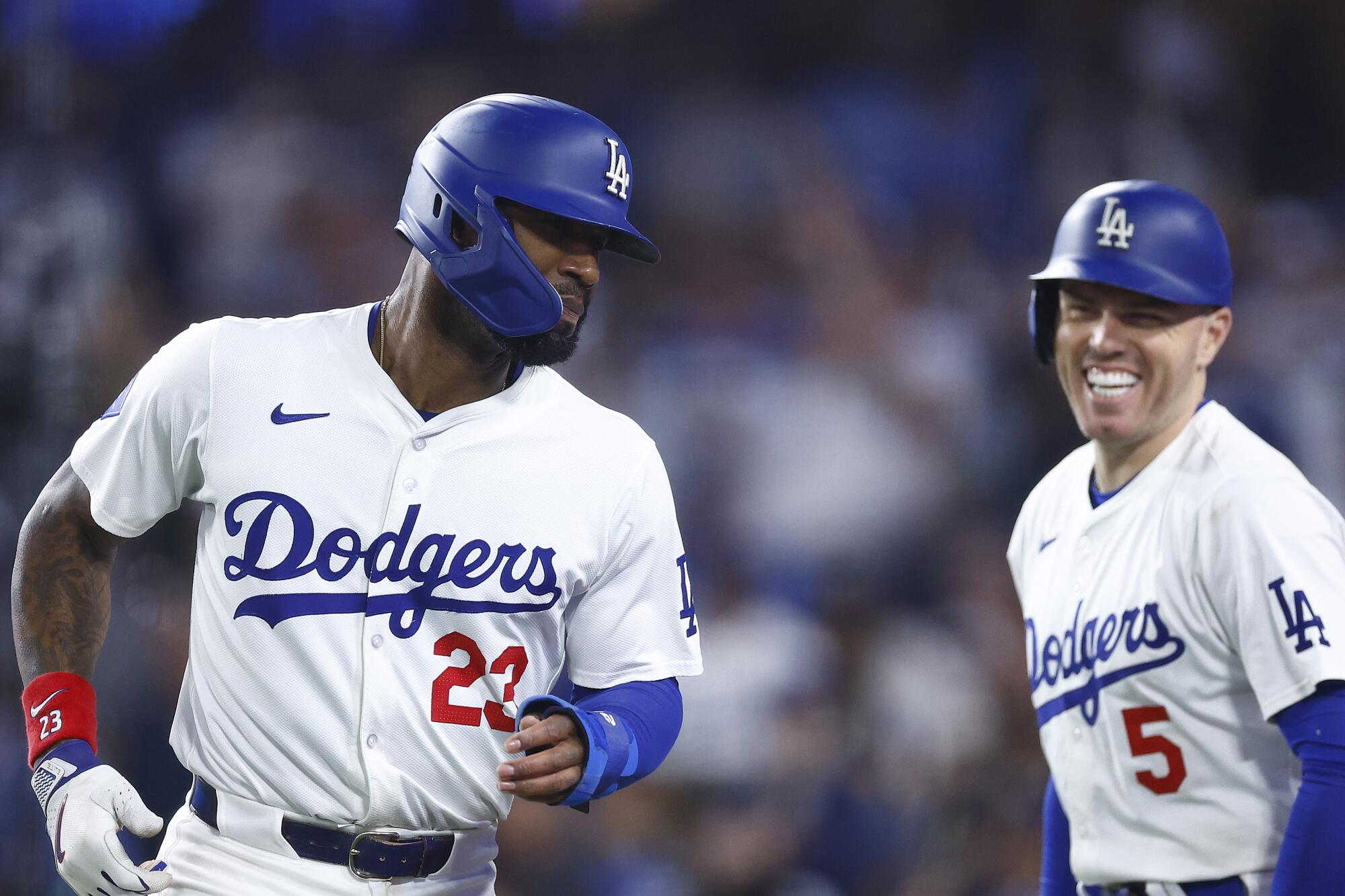 Jason Heyward #23 of the Dodgers celebrates a run with Freddie Freeman #5 against the Texas Rangers in 2024.