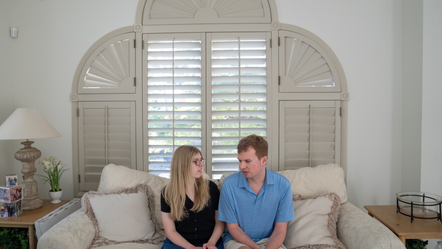 Cody and Kaleigh Brendle sit together at their home.