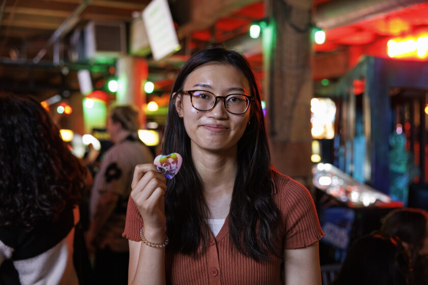 Megan Herrera holds up a BTS pin during BTS trivia night at Replay Lincoln Park at 2833 N Sheffield Ave in Lincoln Park, Tuesday, Aug. 25, 2026.